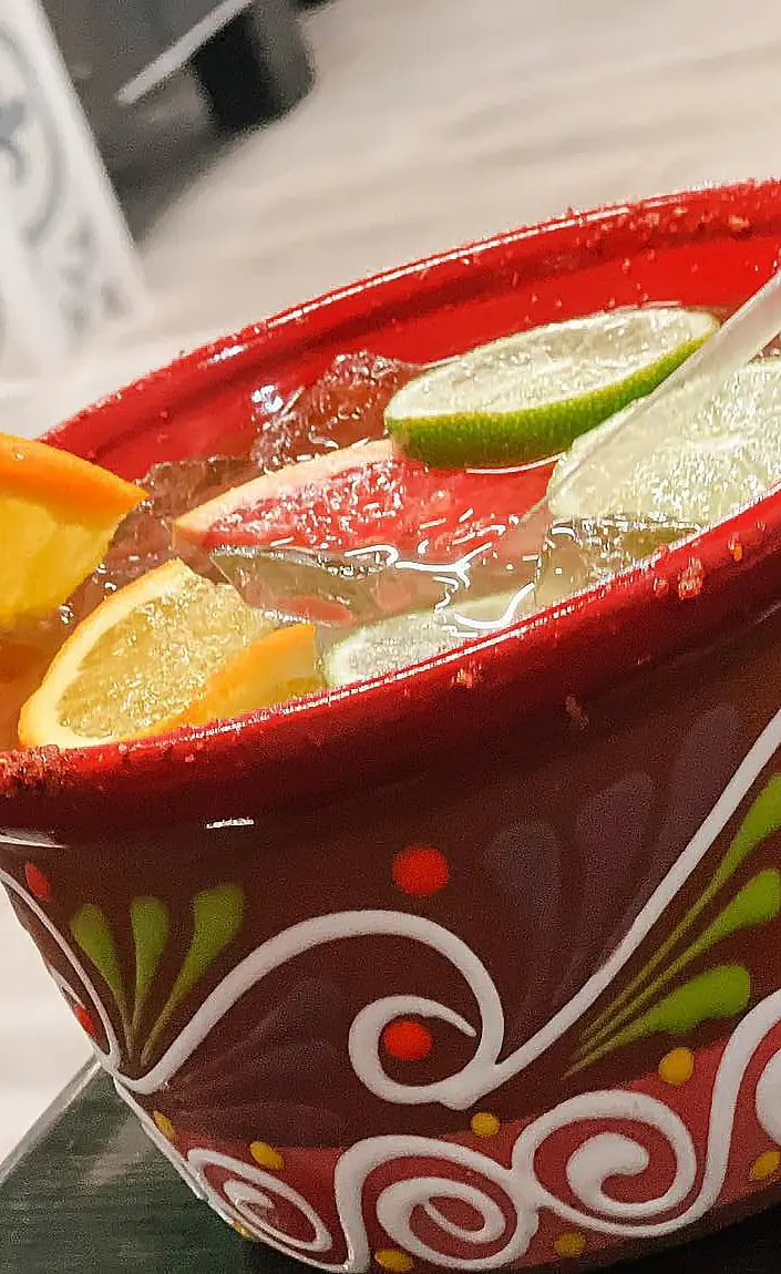 A cazuela cocktail in a painted clay bowl