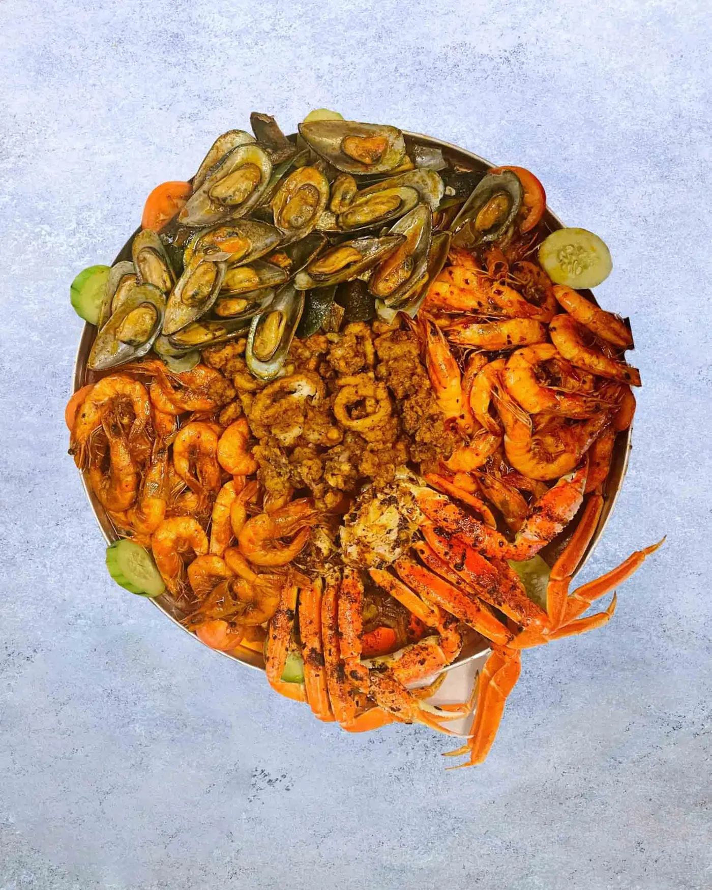 A seafood molcajete with mussels, shrimp and crab, seen from above